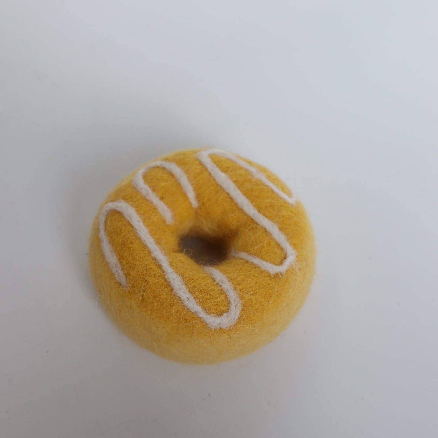 Yellow drizzle donut
